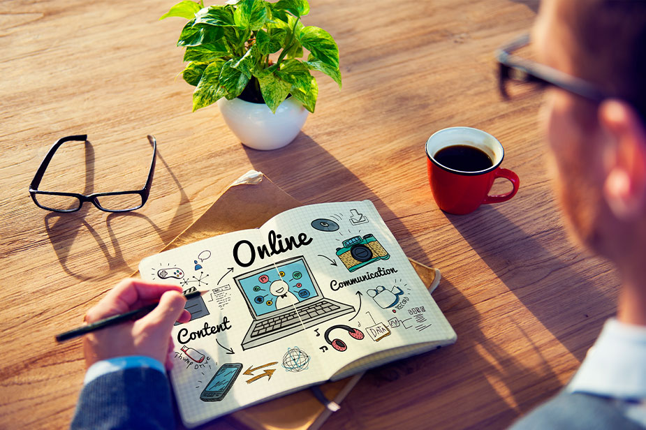 A man creates an SEO strategy with a pen and notebook on the desk.